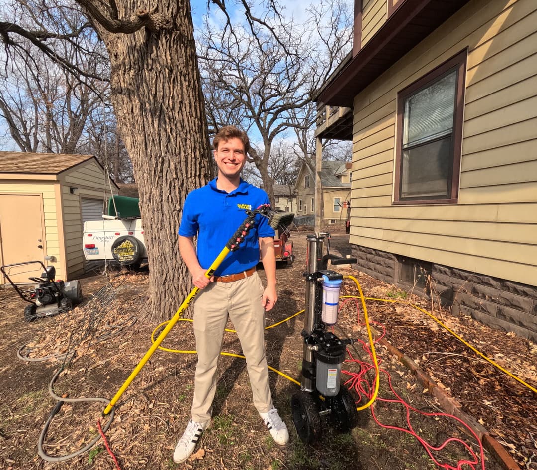 Alex, owner of Gleam Team, with his cleaning equipment